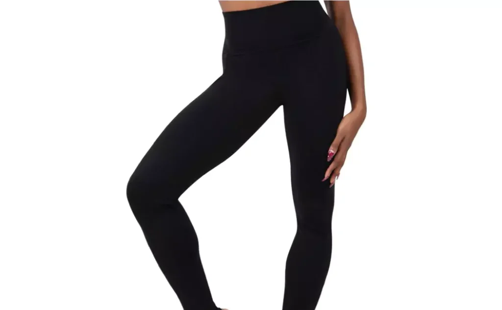 A woman wearing a pair of black stirrup leggings